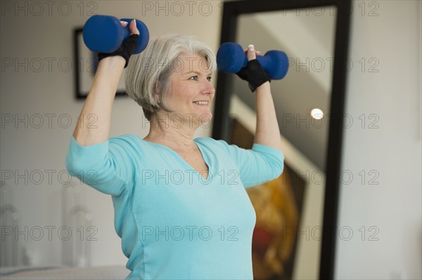 Caucasian woman exercising with hand weights