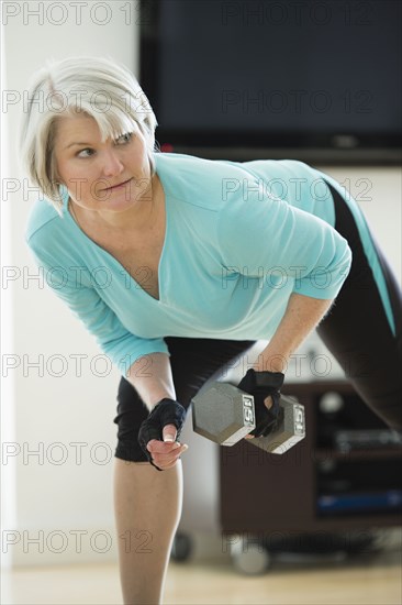 Caucasian woman exercising with hand weights