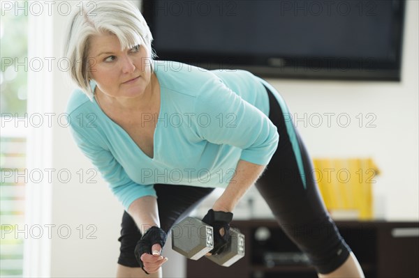 Caucasian woman exercising with hand weights