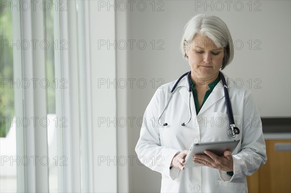 Caucasian doctor using digital tablet