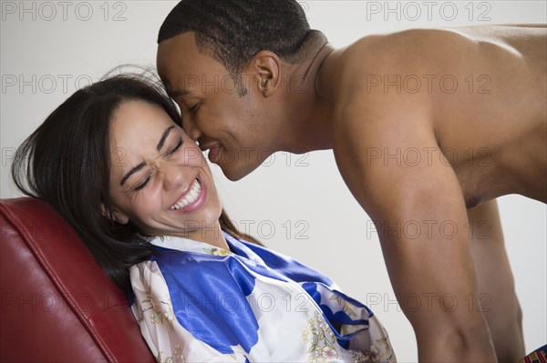 Mixed race man kissing girlfriend