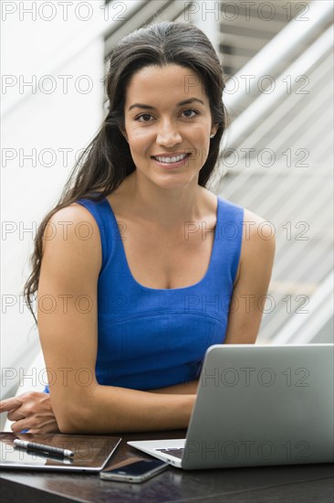 Hispanic woman using laptop