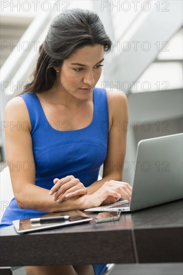 Hispanic woman using laptop