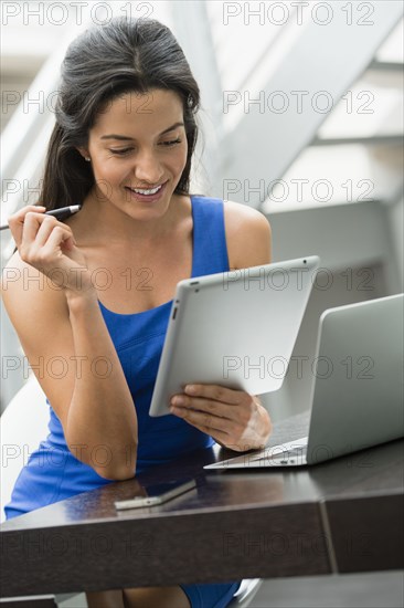 Hispanic woman using digital tablet