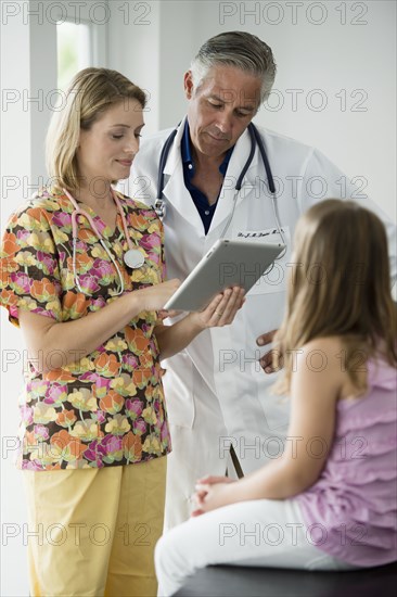 Hispanic girl having checkup in doctor's office