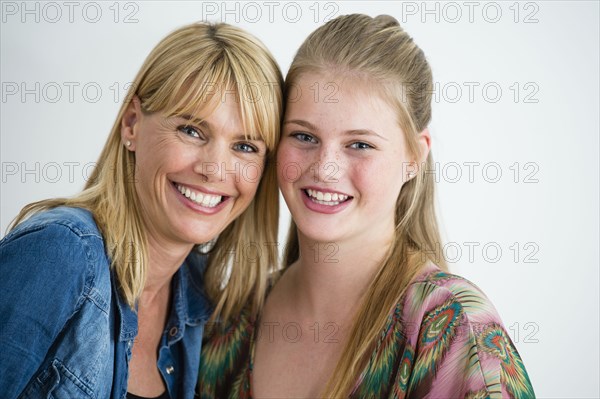 Smiling Caucasian mother and daughter