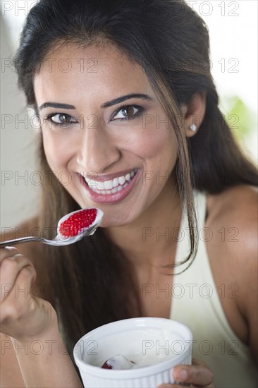 Indian woman eating fruit