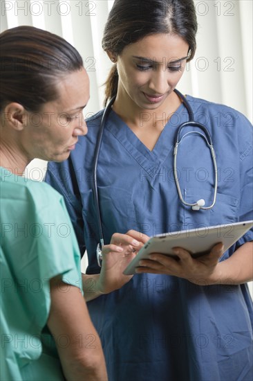 Nurses using tablet computer