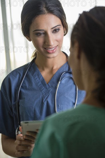 Nurses using tablet computer