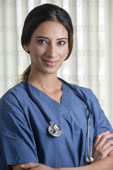 Indian nurse standing with arms crossed