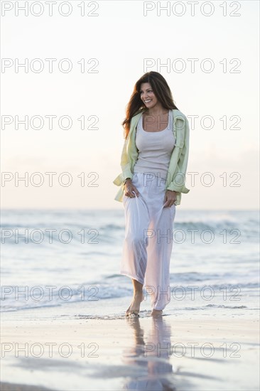 Caucasian woman walking on beach