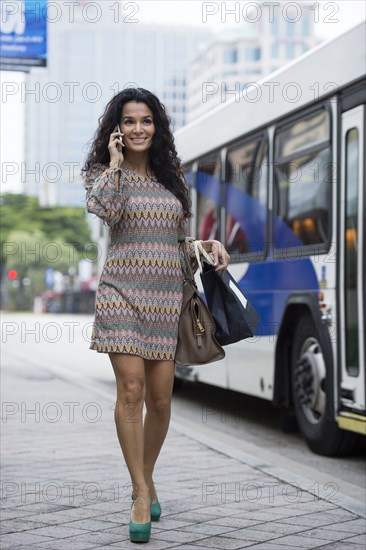 Hispanic woman talking on cell phone