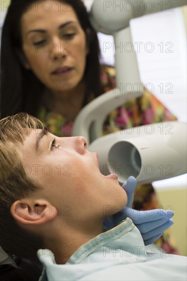 Nurse using equipment on dental patient