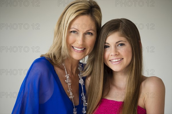 Caucasian mother and daughter smiling