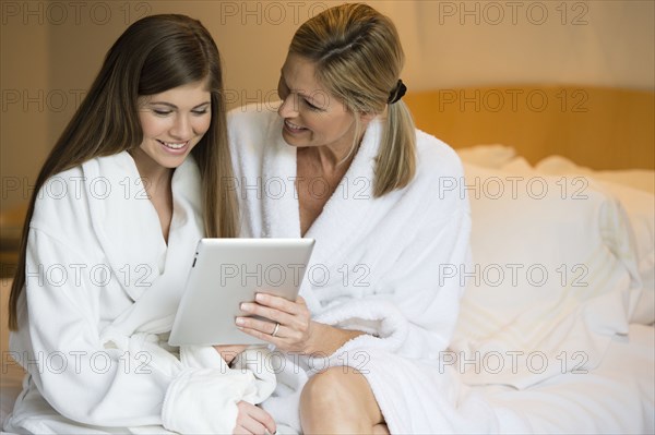Caucasian mother and daughter using tablet computer
