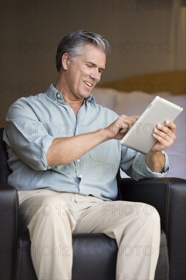 Caucasian man using tablet computer