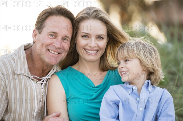 Family hugging outdoors