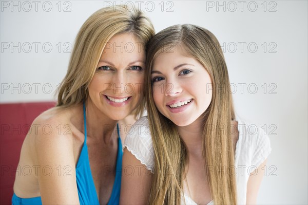 Caucasian mother and daughter smiling together