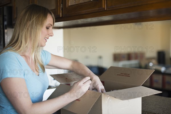 Caucasian woman unpacking in new home