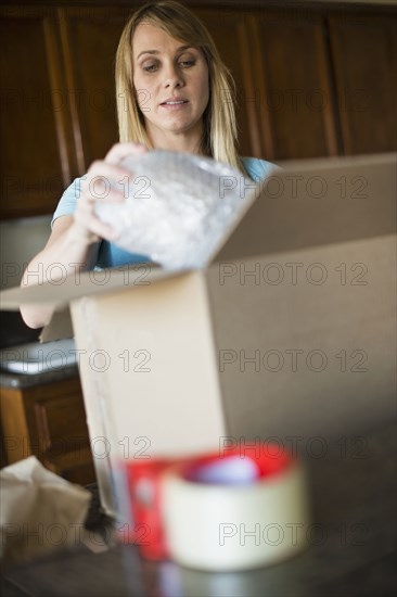 Caucasian woman unpacking in new home