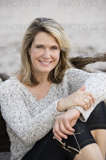 Caucasian woman sitting on beach