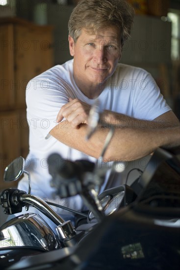 Caucasian man on motorcycle in garage