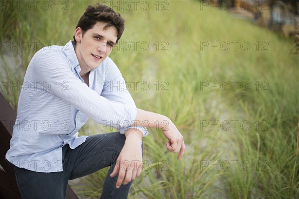 Hispanic man standing in tall grass