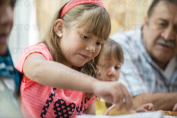 Hispanic family eating dinner at table