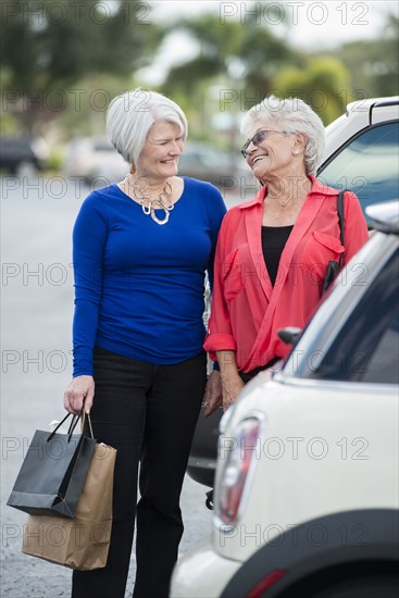 Senior Caucasian women with shopping bags in parking lot