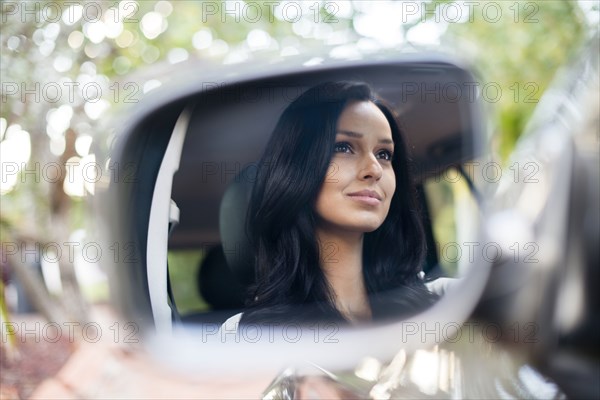 Hispanic woman driving car