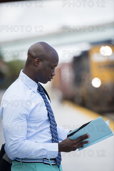 African American businessman waiting for train