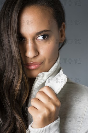 Mixed race woman holding collar