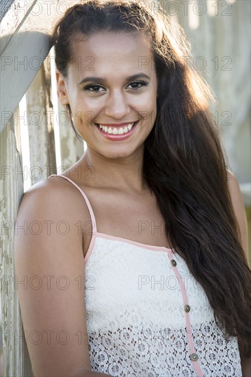 Mixed race woman sitting on wooden steps