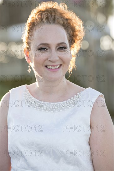 Caucasian woman wearing evening gown outdoors