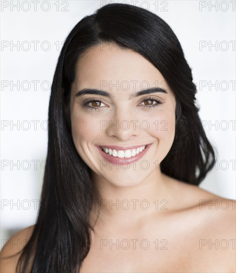 Hispanic woman with long hair smiling