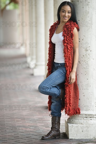 Black woman leaning on pillar