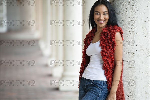 Black woman leaning on pillar