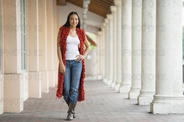 Black woman standing near pillars