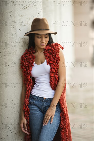 Black woman leaning on pillar