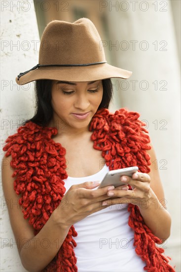 Black woman using cell phone outdoors