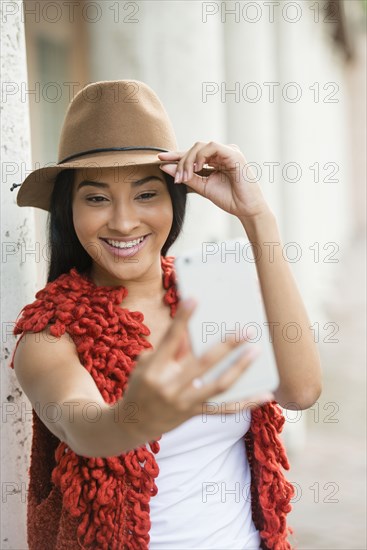 Black woman taking cell phone selfie outdoors