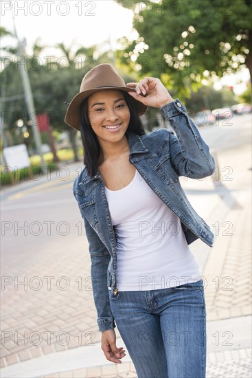 Black woman walking on sidewalk