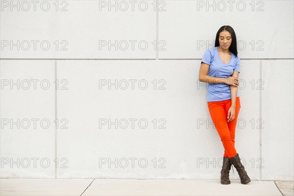 Black woman standing near concrete wall