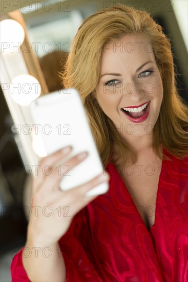 Caucasian woman taking cell phone selfie