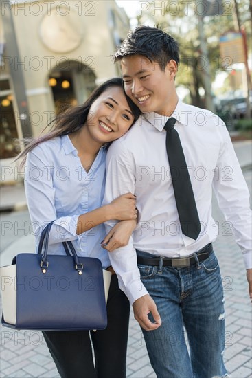 Smiling Korean couple crossing street