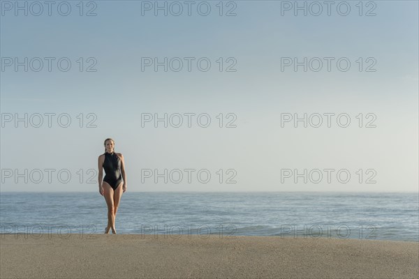 Caucasian woman wearing swimsuit on beach