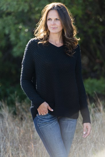 Caucasian woman standing in tall grass