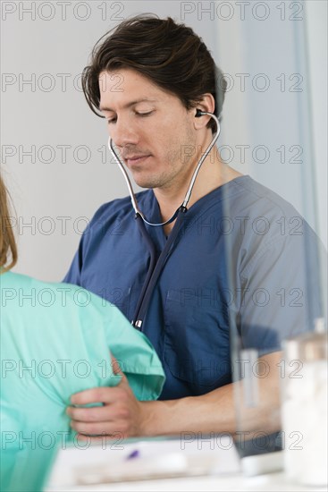 Doctor listening to heartbeat of patient