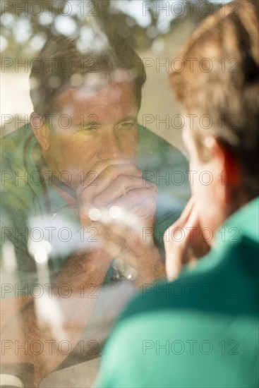 Reflection of Caucasian nurse in window