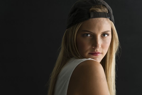 Serious Caucasian woman looking over her shoulder